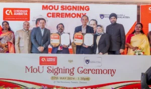 Group of officials from Chennais Amirta International Aviation College and University College of Aviation Malaysia posing with signed MOU documents during the signing ceremony.