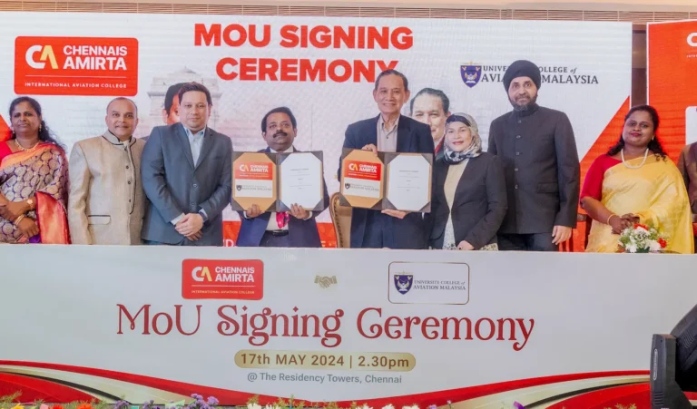 Group of officials from Chennais Amirta International Aviation College and University College of Aviation Malaysia posing with signed MOU documents during the signing ceremony.