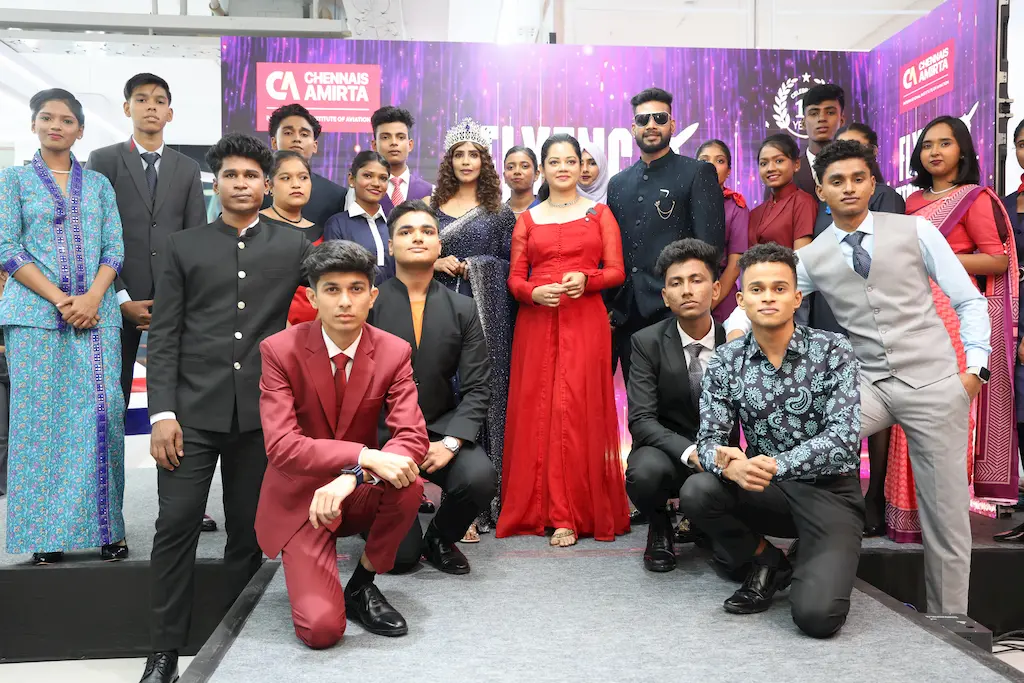 Group photo of Chennais Amirta Aviation College students and guests at the FASHIONISTA 2025 fashion event, including celebrity guest Anitha Sampath and panel judges.