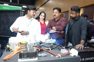 E DADDY team demonstrates the components of their ARAI-approved EV retrofit kit to dignitaries and visitors at EV India Expo 2025, showcasing electric wiring and battery systems on display.