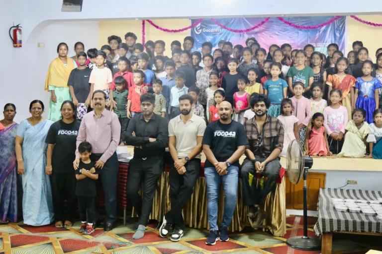 Food42 – 2025 campaign launch event showing actors Santhosh Prathap and Raanav, Goodness Foundation team members, and dozens of children from the community gathered together symbolizing the collective effort to combat hunger in India.