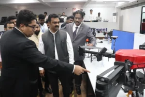 Hon'ble Union Minister Shri Kamlesh Paswan observes an Agri-drone during the inauguration of Garuda Aerospace’s Indigenization Facility, accompanied by company executives and officials.