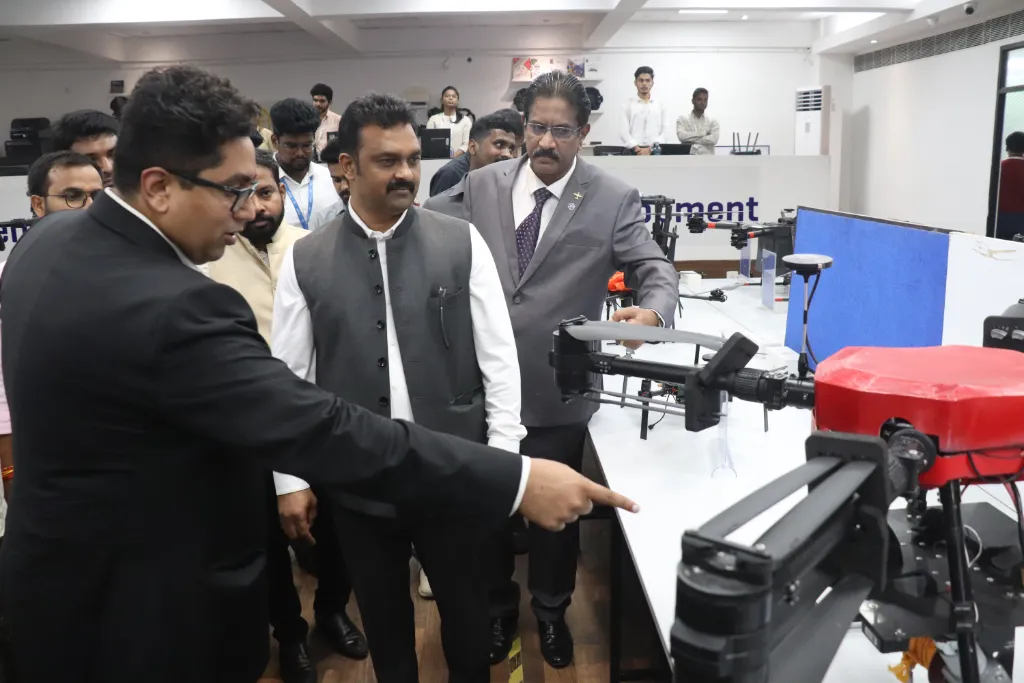 Hon'ble Union Minister Shri Kamlesh Paswan observes an Agri-drone during the inauguration of Garuda Aerospace’s Indigenization Facility, accompanied by company executives and officials.