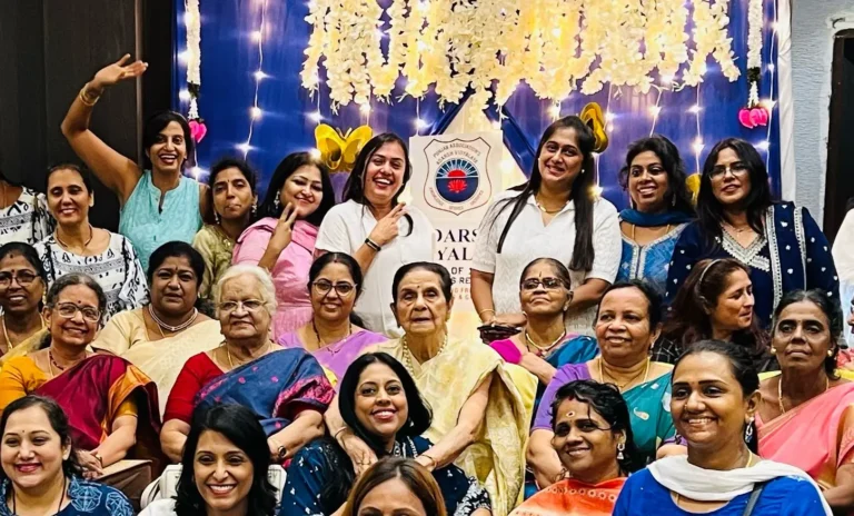 Group photo of Adarsh Vidyalaya alumni and teachers at the 25th reunion, featuring 92-year-old former Principal Nirmal Basin at the center, surrounded by smiling attendees in traditional attire.