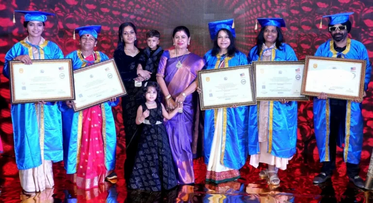 Sanchita Shetty, Rakhi Shah, Tara Kerkar, and other recipients pose with their Honorary Doctorate certificates at the award ceremony in Coimbatore, wearing blue academic gowns and caps, joined by guests and children.