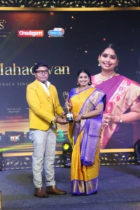 D. Imman presenting the Fab Stars Iconic Award to singer Nithyashree Mahadevan