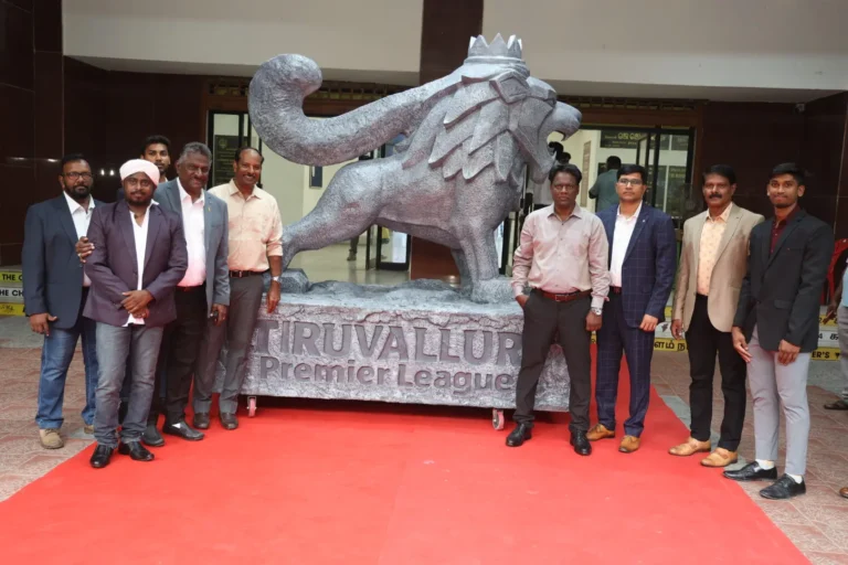 Officials and dignitaries posing beside the Tiruvallur Premier League lion mascot statue during the TPL 3.0 launch event at Mayor Radhakrishnan Stadium.
