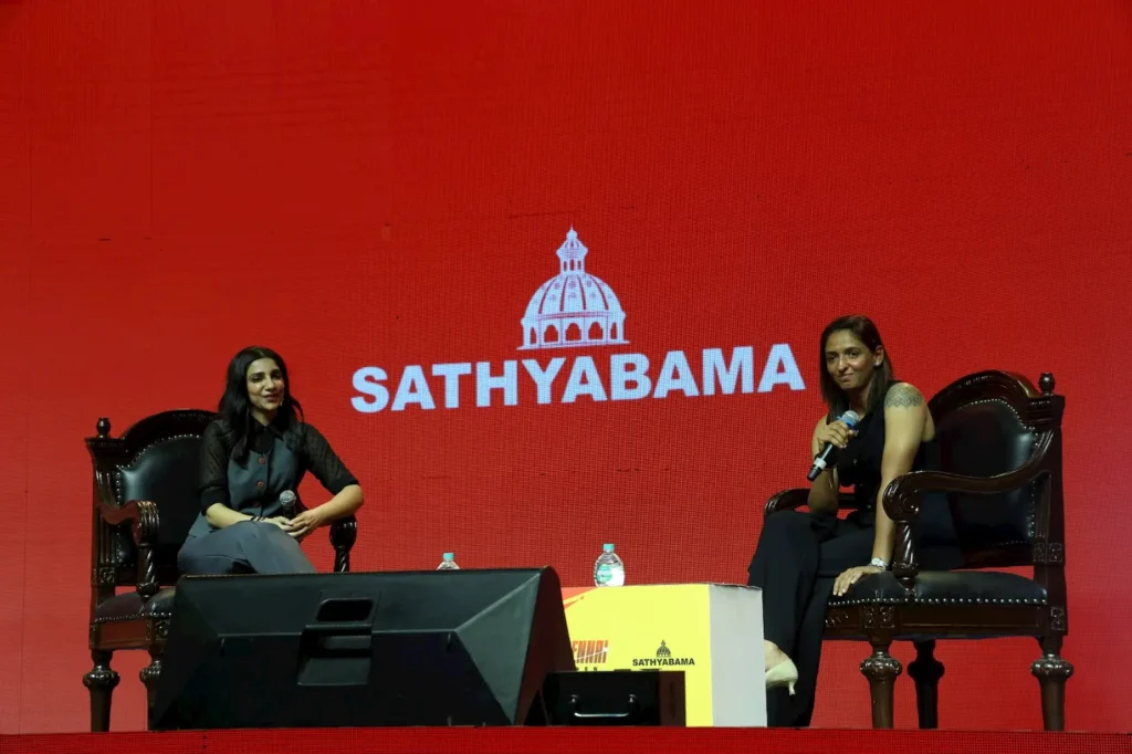 Harmanpreet Kaur seated on stage during an interactive session at Sathyabama University