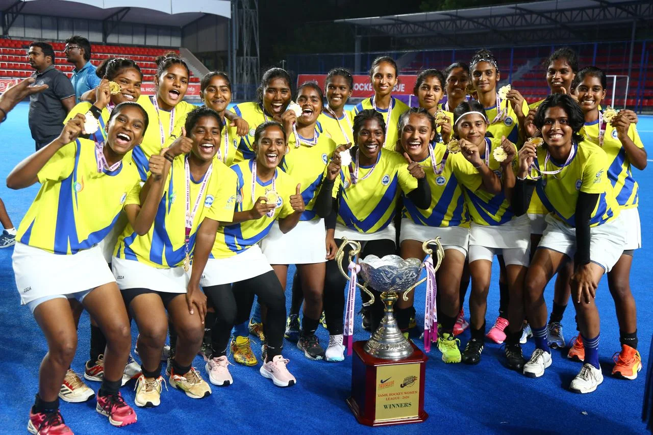 SRM women's hockey team celebrating THL 2026 title win with medals and trophy